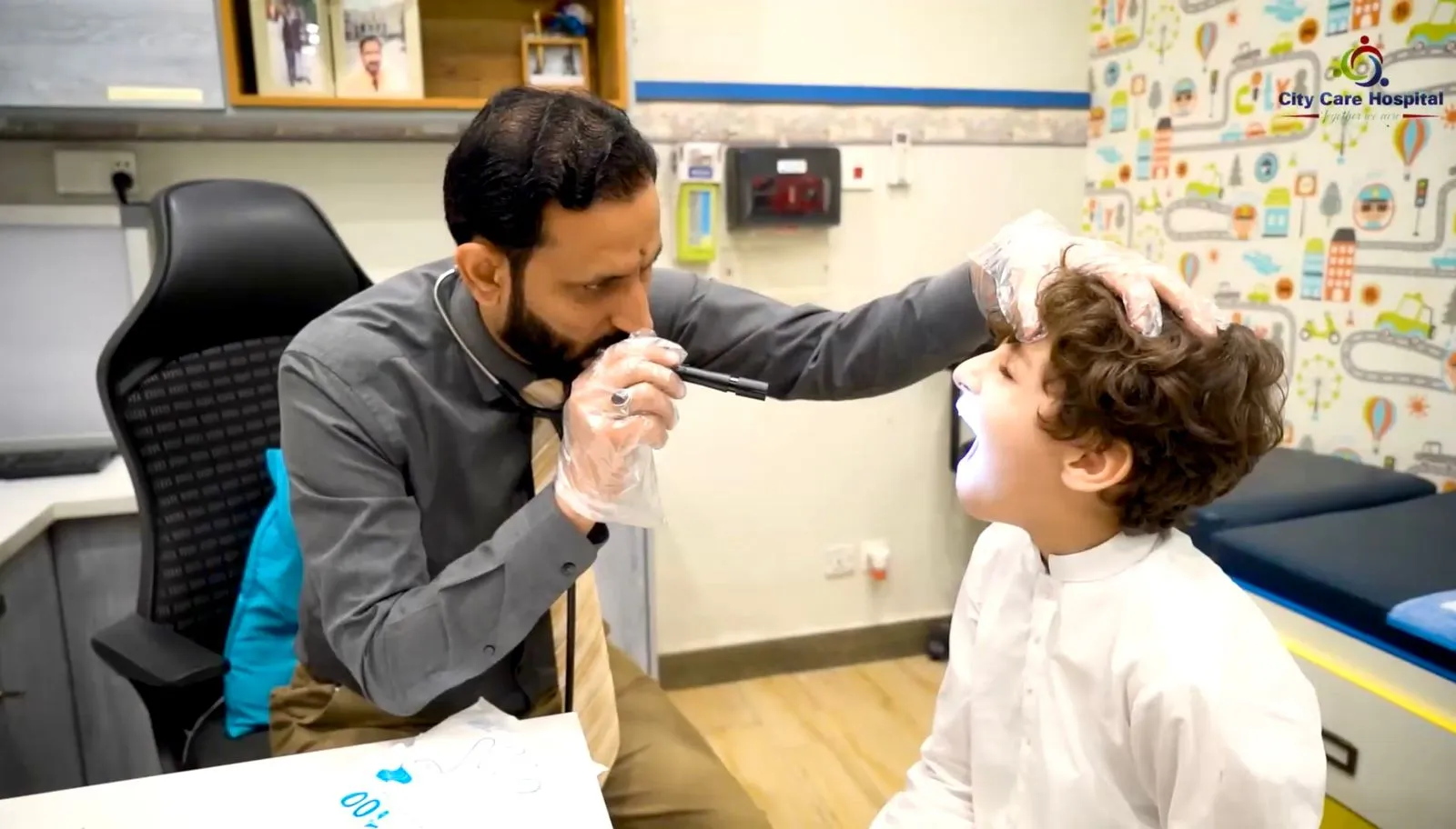 Dr. Raja Imran pediatrician in Rawalpindi examining a child during medical consultation